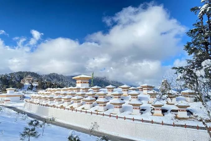 The 108 chortens at Dochula pass, the Himalaya behind them
