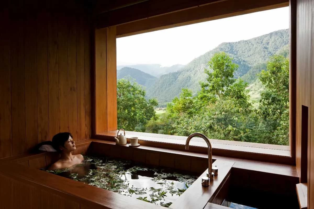 A Bhutanese hot stone bath — river stones, artemisia, and a wooden tub